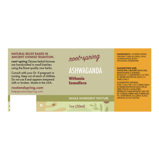 A rectangular product label for Root+Spring Ashwaganda tincture, with a cream and orange design, product details, ingredients, and a small illustration of green leaves at the bottom.