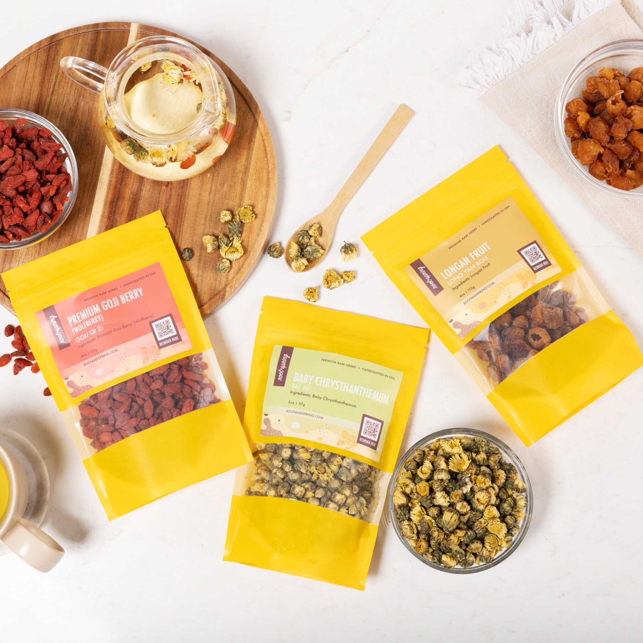 Lifestyle image of raw herbs Premium Goji Berry, Baby Chrysthanthemum, and Longan Fruit