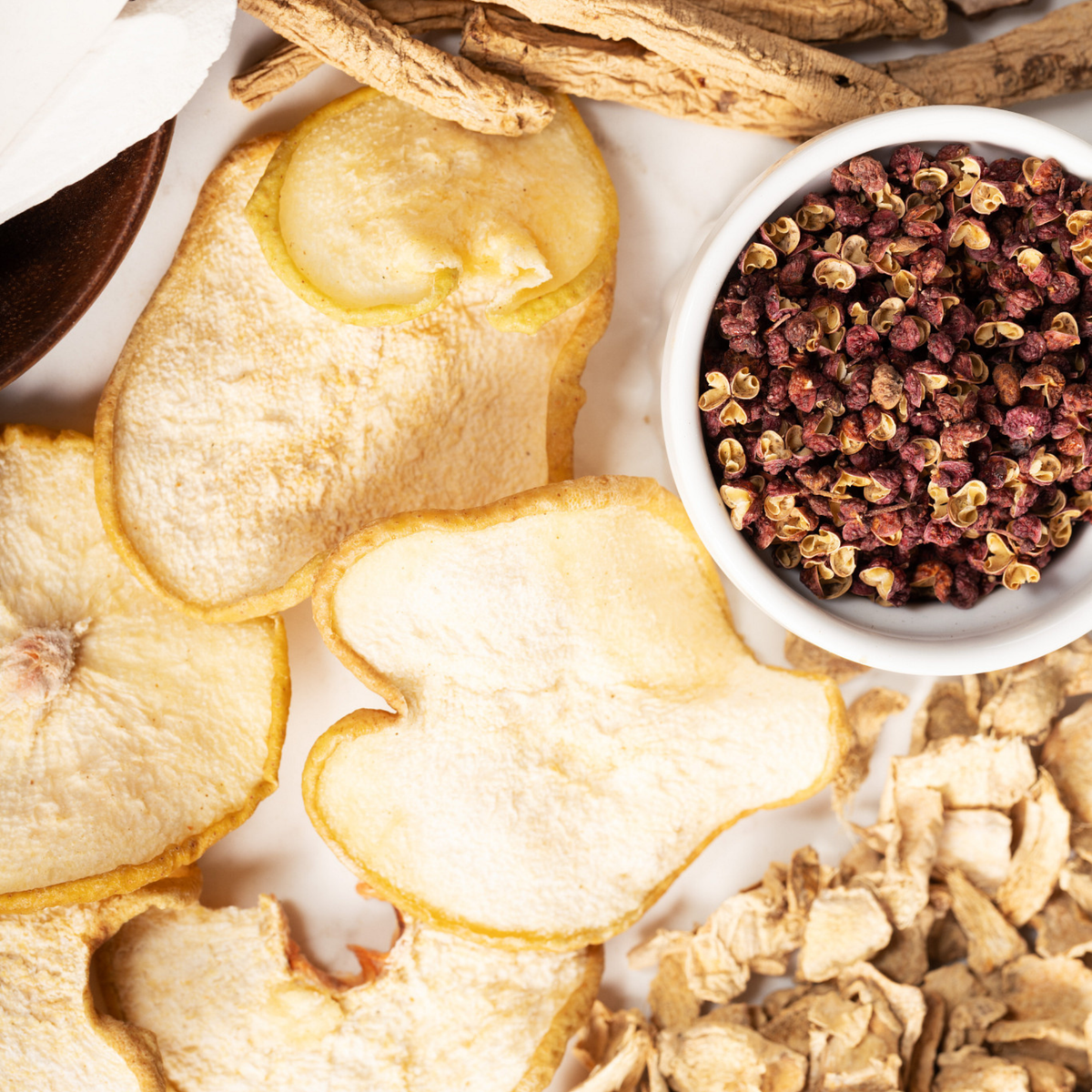 Prickly Ash, Dried Asian Pear, Codonopsis, Dried Ginger arranged on a light surface