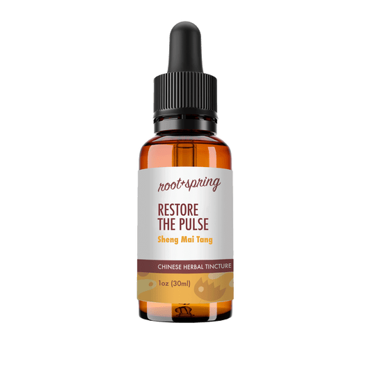 A 1 oz amber glass dropper bottle of Root+Spring Restore the Pulse Chinese Herbal Tincture, featuring a white label with brown and yellow text, and a black dropper cap, isolated on a white background.